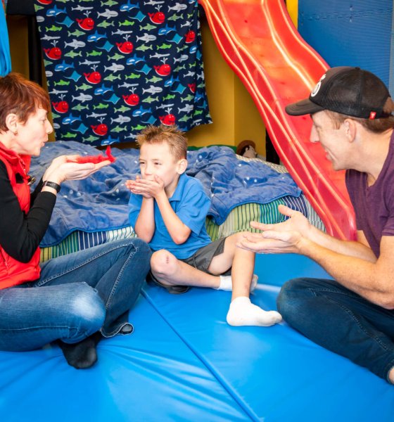 A therapist and family discussing a child’s development